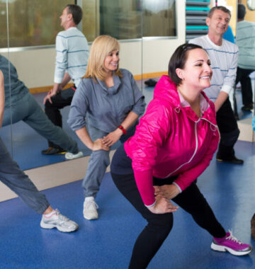 Group of adults doing aerobics exercise in sport club