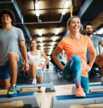 Group of young people doing exercises in gym